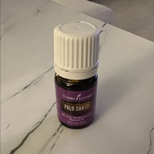Young Living Palo Santo Oil in Purple and White